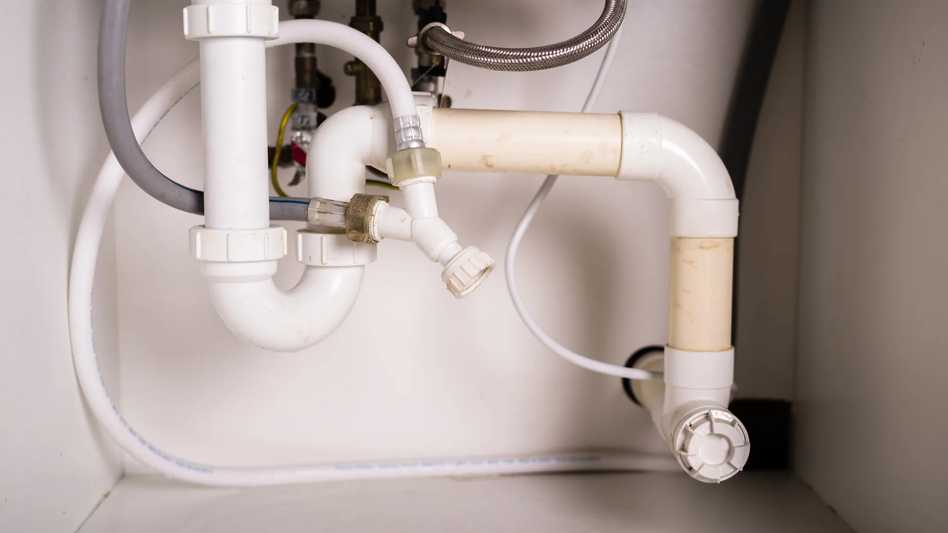 Under-sink waste trap, pipes and fittings, illustrative household plumbing repairs photo