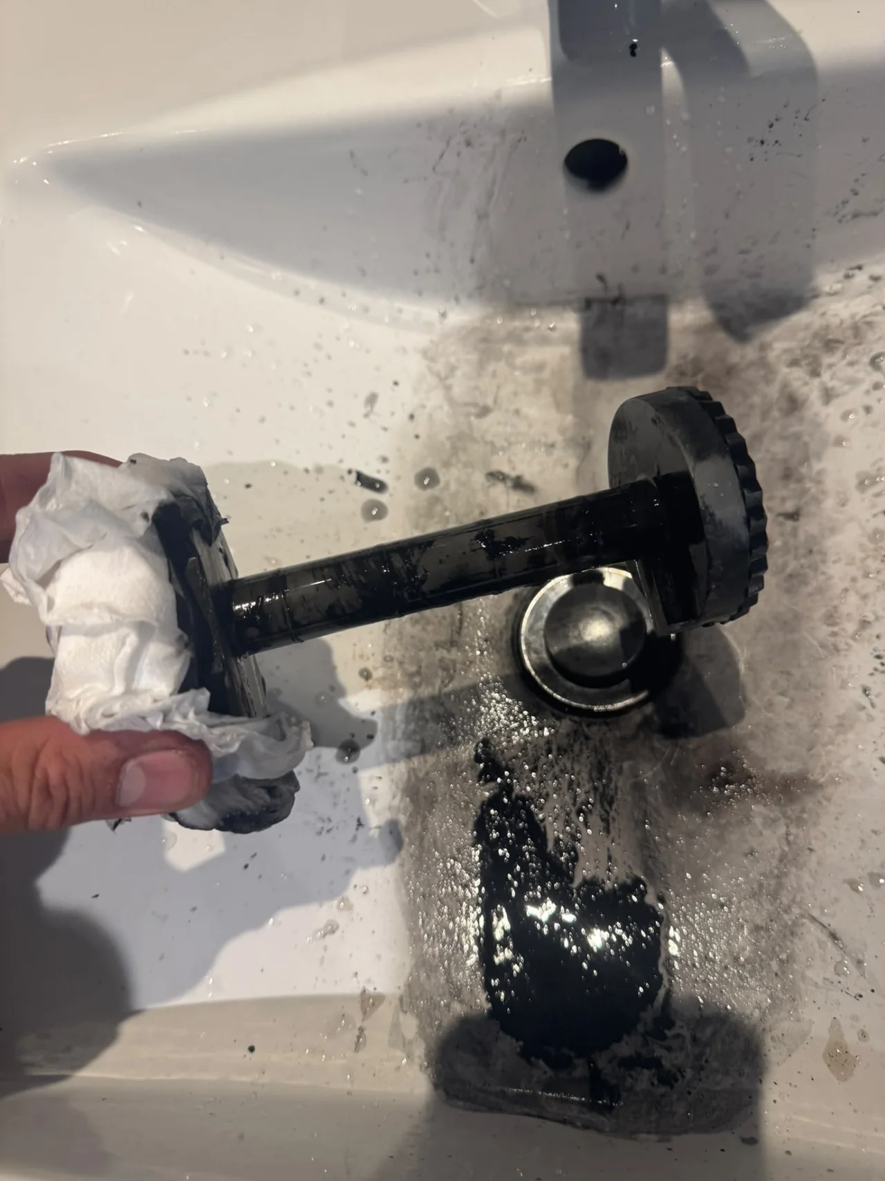 Magnetic filter being cleaned with the collected sludge removed