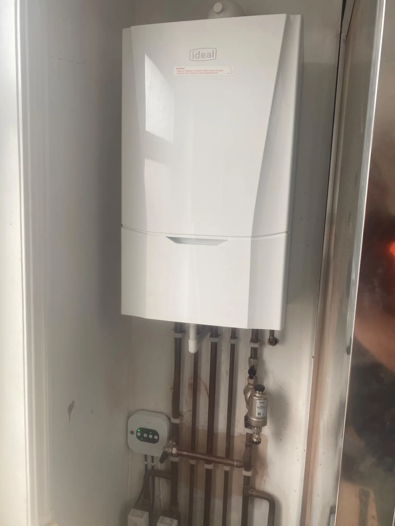 Ideal boiler with connected copper pipework and system filter installed by DPB