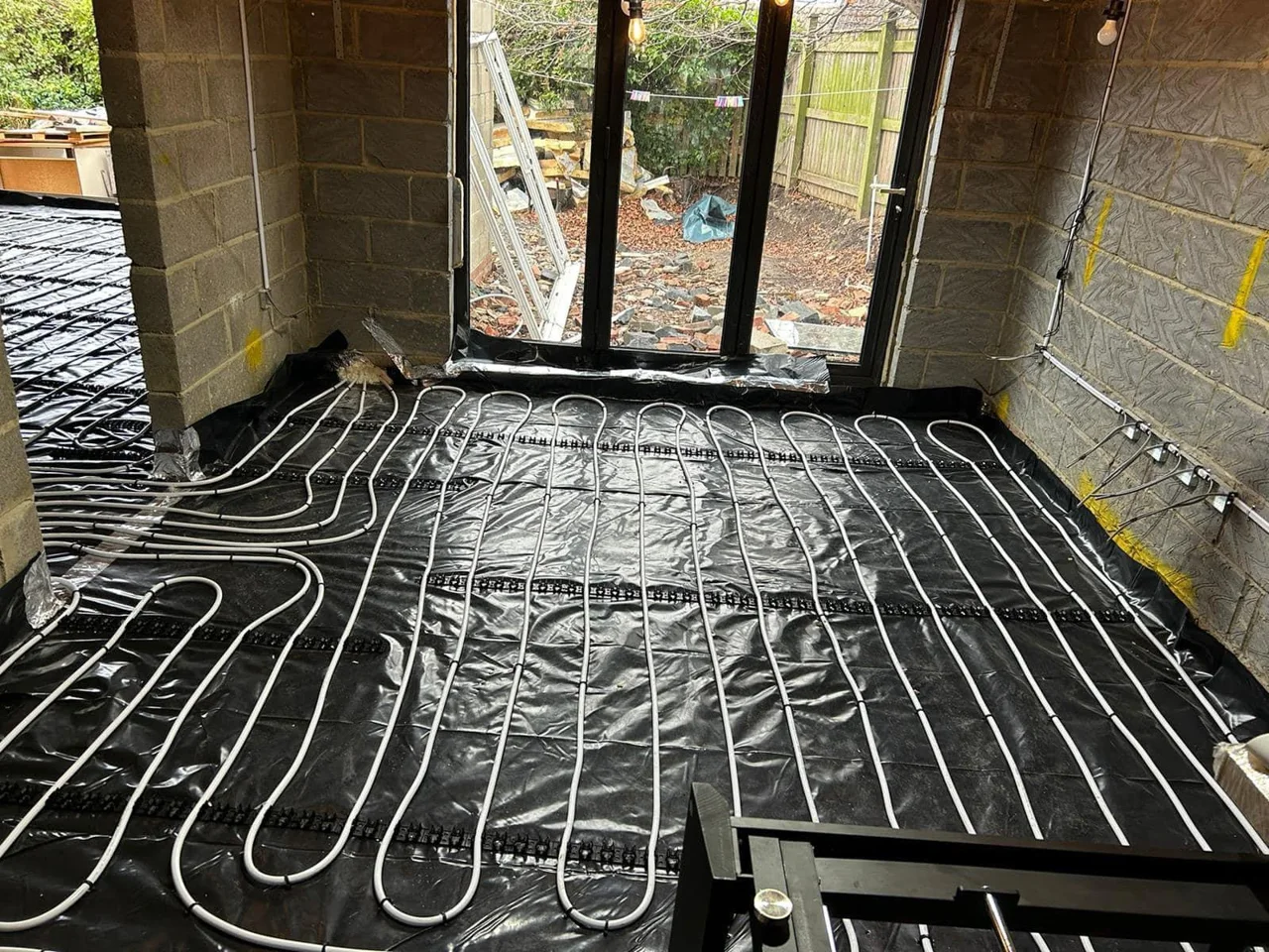 Underfloor heating pipe loops laid before the floor is finished by DPB