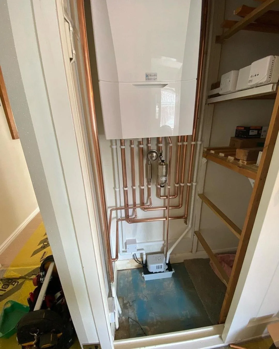 Boiler installation with neatly routed copper pipes and condensate pump by DPB